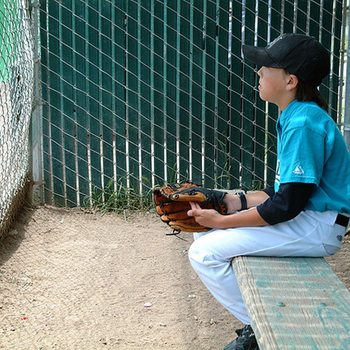 Find and Fix Your Weakest Link to Kickstart Progress 7 Young baseball player sitting on the sidelines