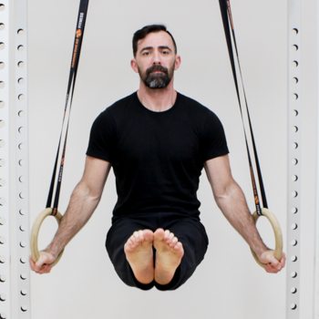 Hand Wraps, Grips, & Other Hand Care Methods for Using Gymnastic Rings 3 Ryan Hurst performing an l sit on gymnastics rings