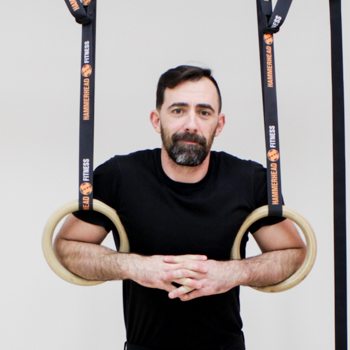 Hand Wraps, Grips, & Other Hand Care Methods for Using Gymnastic Rings 7 Ryan Hurst relaxing with gymnastics rings