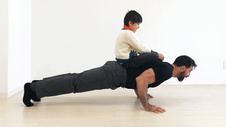 kid on dad doing pushups