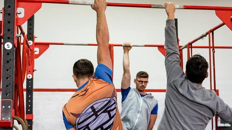 Seminars & Events 3 Athletes perfecting their grip on a pole
