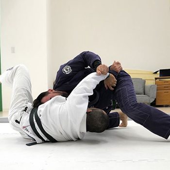 What Does it Mean to Have a Gold Medal Body? 4 athletes grappling in Brazilian Jiu Jitsu
