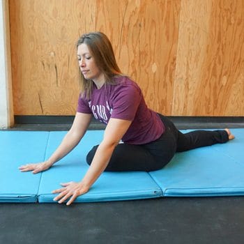 Stacey performing a pigeon stretch