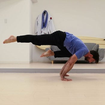 How to Get into the Crow Pose, Even if You've Never Been Able to Do It 6 Ryan doing a one legged crow exercise
