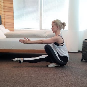 Training While Traveling: Maintaining an Exercise Routine On The Go 7 Alicia doing a pistol squat in a hotel room