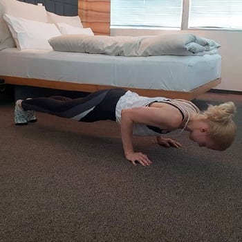 Training While Traveling: Maintaining an Exercise Routine On The Go 2 Alicia doing a push up in a hotel room