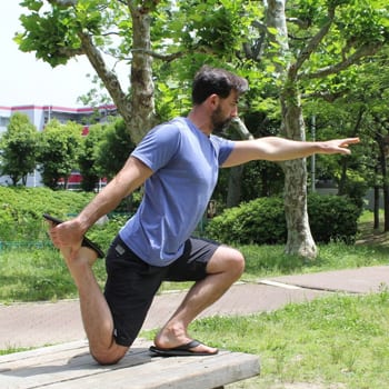 Training While Traveling: Maintaining an Exercise Routine On The Go 8 Ryan doing shrimp squat exercise outside