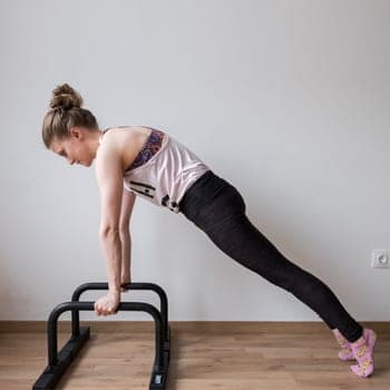 Build Up Your Bent Arm Strength With Parallettes Push Ups & Dips 2 Alicia doing a push up on parallettes