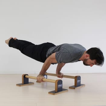 How to Build Your Own Parallettes (And the Best Options Money Can Buy) 5 Ryan doing an arm lever exercise on parallettes