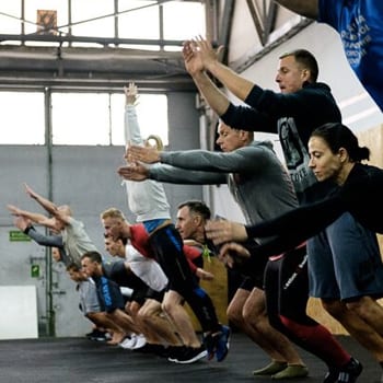 Group class doing broad jumps