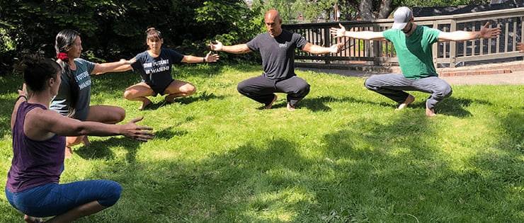 Exercising Barefoot In The Grass Squatting barefoot in the grass