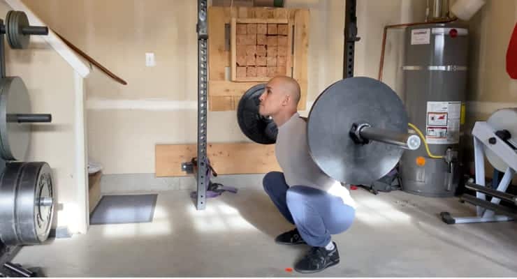 Should Your Knees Go Past Your Toes When Squatting? 2 Jarlo doing the barbell Olympic squat