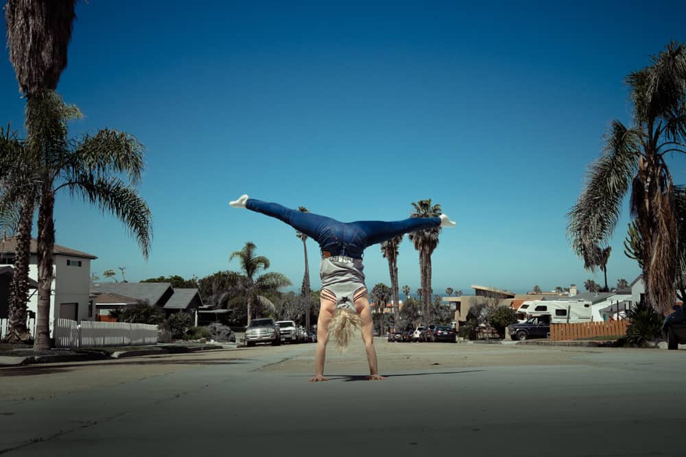 woman doing a handstand on the street in san diego