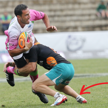 Man tackling another playing rugby