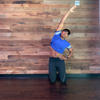 Tall kneeling reaching to side to stretch shoulders