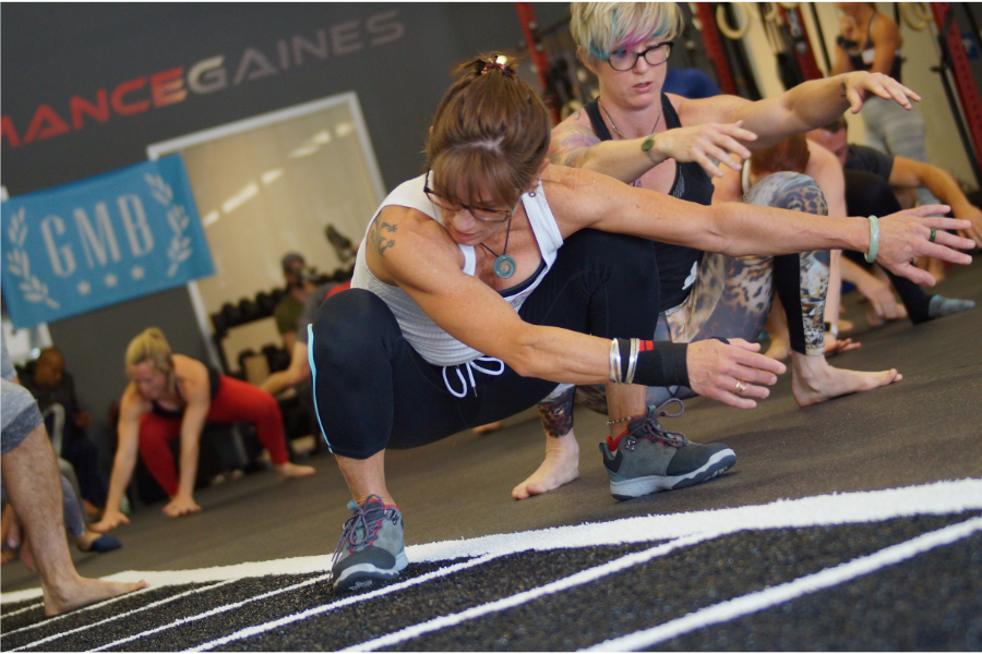 Women exercising in squatting locomotions
