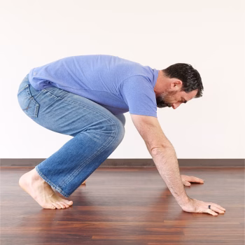 Person demonstrating a strong, grounded squat—starting position for a controlled burpees